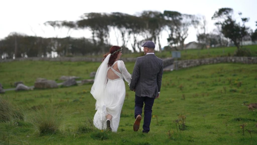 bride and groom walk trees