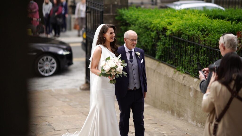 Bride and father arrive at Cathedral in Fermanagh, Northern Ireland in an image from the wedding video