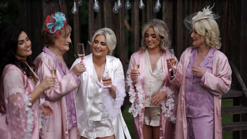 bride and bridesmaids share champagne before going to beech hill for the wedding celebrations