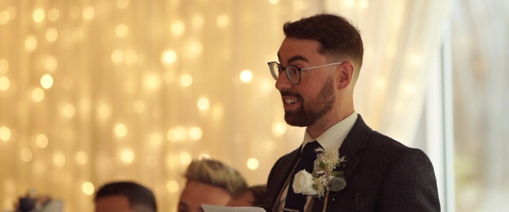 groom Dominick addresses the crowd in beech hill in a still image from the wedding video