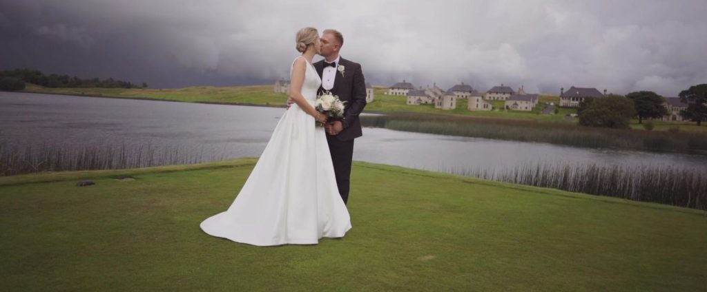 With Lough Erne Resort in the background the happy couple share a moment