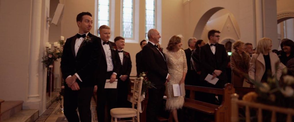 Evan looks down the aisle to his bride Niamh