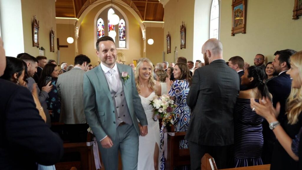 bride and groom just married walk down aisle